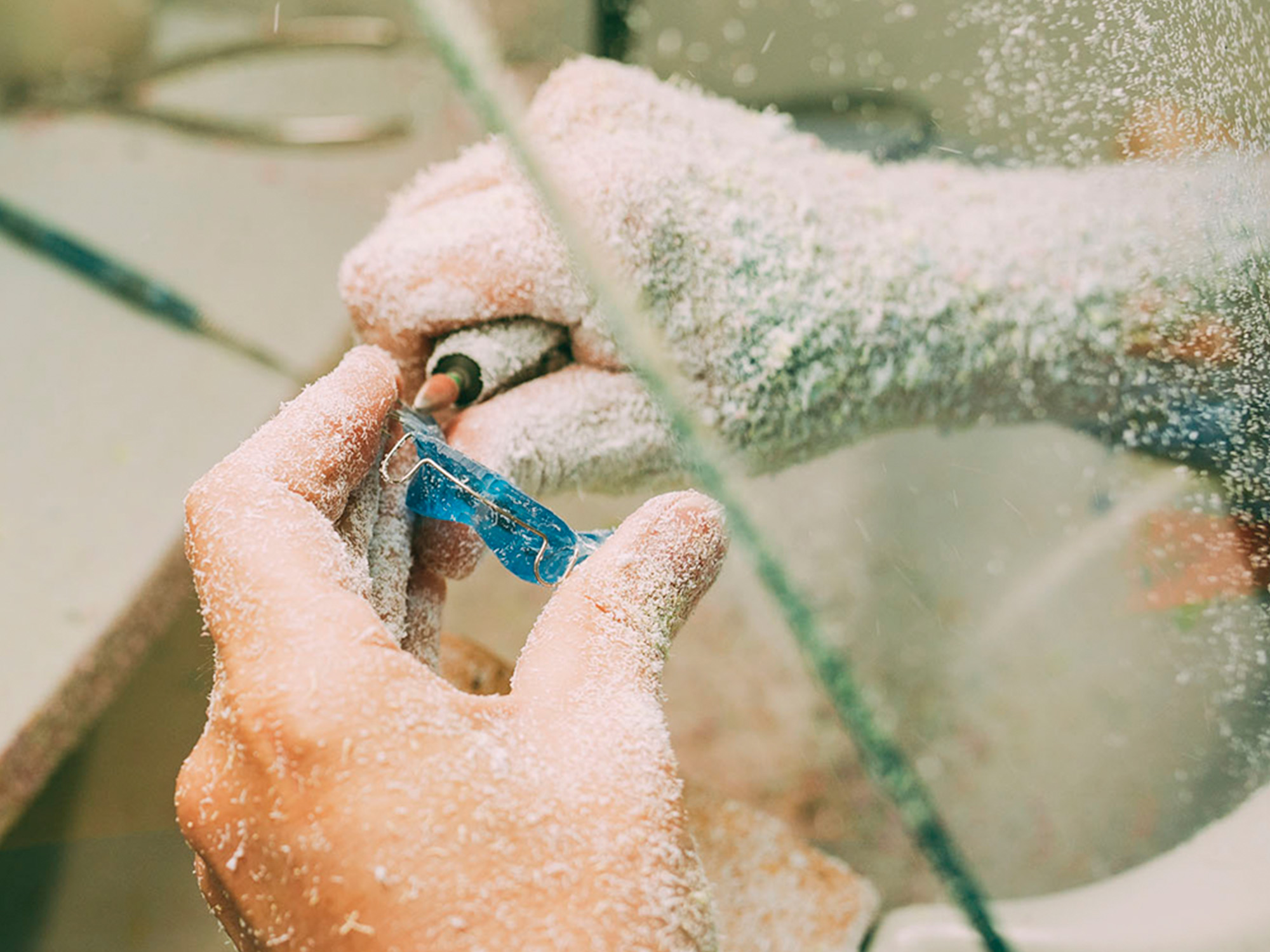 Ein Zahntechniker bearbeitet bei docs & bears in Ditzingen eine blaue Zahnspange für eine optimale Kieferorthopädie.